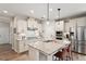 Bright kitchen features stainless steel appliances, granite countertops, and a large center island at 1008 Sounding Ln, Durham, NC 27703