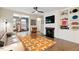 Cozy living room with a fireplace and built-in shelving for ample storage space at 1008 Sounding Ln, Durham, NC 27703
