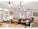Open-concept living room and dining area with modern lighting and stylish furnishings at 1008 Sounding Ln, Durham, NC 27703