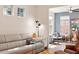 Inviting living room with modern furniture, hardwood floors, and ample natural light from multiple windows at 1008 Sounding Ln, Durham, NC 27703