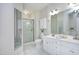 Bright bathroom features a double vanity, a separate shower, and white marble floors at 1023 Kelton Cottage Way, Morrisville, NC 27560