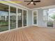 Covered back porch with wood flooring, sliding doors, a ceiling fan, and views of the backyard at 1036 Smoke Willow Way, Rolesville, NC 27571