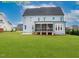 Expansive backyard view featuring a screened porch and lush green lawn, perfect for outdoor activities at 1036 Smoke Willow Way, Rolesville, NC 27571