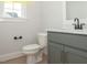 Powder room featuring wood flooring, a toilet, and a grey vanity with marble countertop at 1036 Smoke Willow Way, Rolesville, NC 27571