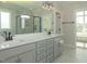 Beautiful bathroom with double marble vanity, sleek fixtures, glass shower, and lots of light at 1036 Smoke Willow Way, Rolesville, NC 27571