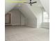 Spacious bonus room featuring neutral carpet, angled ceilings, recessed lighting, and a window at 1036 Smoke Willow Way, Rolesville, NC 27571