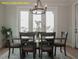 Dining area featuring a modern chandelier, table with seating for six, and large windows at 1036 Smoke Willow Way, Rolesville, NC 27571