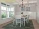 Elegant dining room with coffered ceiling, wainscoting, and large windows offering an abundance of natural light at 1036 Smoke Willow Way, Rolesville, NC 27571
