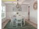 Bright dining room with wainscoting, coffered ceilings, stylish chandelier, and natural light at 1036 Smoke Willow Way, Rolesville, NC 27571