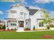 Charming two-story home featuring a mix of board and batten and shake siding, complemented by professional landscaping at 1036 Smoke Willow Way, Rolesville, NC 27571