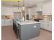 Spacious kitchen featuring a large center island, pendant lighting, and ample counter space and modern appliances at 1036 Smoke Willow Way, Rolesville, NC 27571