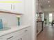 Charming kitchen space with white cabinets, stainless steel appliances, and hardwood floors leading to dining area at 1036 Smoke Willow Way, Rolesville, NC 27571