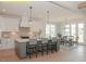 Bright kitchen featuring a large island with seating, white cabinets, stainless appliances, and an eat-in dining area at 1036 Smoke Willow Way, Rolesville, NC 27571