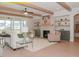 Inviting living room featuring wood beams, fireplace, built-in shelving, and plenty of natural light at 1036 Smoke Willow Way, Rolesville, NC 27571
