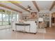 Bright living room showcasing wood beams, a fireplace, built-in shelves, and access to a screened-in porch at 1036 Smoke Willow Way, Rolesville, NC 27571
