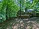Backyard featuring a wooden deck and wooded landscape at 1104 Theresa Ct, Raleigh, NC 27615