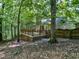 Secluded backyard with a wooden deck, enveloped by lush trees, offers a private outdoor retreat at 1104 Theresa Ct, Raleigh, NC 27615