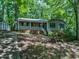 Charming single-story home nestled among mature trees features a welcoming front porch and a storage shed at 1104 Theresa Ct, Raleigh, NC 27615