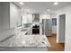 Modern kitchen with stainless steel appliances, granite countertops, and ample cabinet space at 1104 Theresa Ct, Raleigh, NC 27615