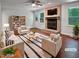 Bright living room boasts a brick fireplace, ceiling fan, and modern furniture at 1104 Theresa Ct, Raleigh, NC 27615