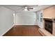 Large living room with brick fireplace, hardwood floors, and lots of light at 1104 Theresa Ct, Raleigh, NC 27615
