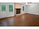 Bright living room with hardwood floors and a brick fireplace at 1104 Theresa Ct, Raleigh, NC 27615
