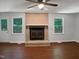 Spacious living room features wood floors and a brick fireplace at 1104 Theresa Ct, Raleigh, NC 27615