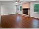 Spacious living room features wood floors and a brick fireplace at 1104 Theresa Ct, Raleigh, NC 27615