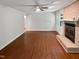 Spacious living room with hardwood floors, fireplace, and ceiling fan at 1104 Theresa Ct, Raleigh, NC 27615