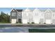 Charming townhome showcasing the exterior with gray siding, black front door and an attached garage at 1105 Weavers Trace Dr, Zebulon, NC 27597