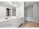 Bright bathroom showcasing a double sink vanity with tile floors and a separated shower at 11220 Avocet Ln # 104, Raleigh, NC 27617