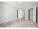 Bedroom featuring carpet, neutral walls, and an open doorway leading to other rooms at 11220 Avocet Ln # 104, Raleigh, NC 27617