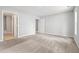 This bedroom features neutral walls, carpet, and an open doorway leading to other rooms at 11220 Avocet Ln # 104, Raleigh, NC 27617