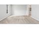 An empty bedroom featuring plush carpeting, neutral paint, and natural light from a window at 11220 Avocet Ln # 104, Raleigh, NC 27617