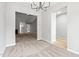 Open-concept space showcasing the dining area with a chandelier, carpet, and seamless flow to other living areas at 11220 Avocet Ln # 104, Raleigh, NC 27617