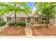 Inviting townhome featuring a mix of brick and stone accents, complemented by lush landscaping and a welcoming entrance at 11220 Avocet Ln # 104, Raleigh, NC 27617