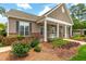 Community clubhouse entrance features classic columns and manicured landscaping at 11220 Avocet Ln # 104, Raleigh, NC 27617