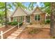 Charming townhouse with stone and brick accents, manicured landscaping, and a welcoming entrance amidst mature trees at 11220 Avocet Ln # 104, Raleigh, NC 27617