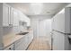 Clean kitchen with white cabinets, tile floor, and modern appliances, offering a functional and tidy cooking space at 11220 Avocet Ln # 104, Raleigh, NC 27617