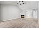 Spacious living room boasting a vaulted ceiling, ceiling fan, cozy fireplace, and neutral carpet at 11220 Avocet Ln # 104, Raleigh, NC 27617