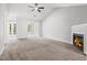 Bright and airy living room featuring a fireplace, carpet flooring, and easy access to a sunroom and dining area at 11220 Avocet Ln # 104, Raleigh, NC 27617