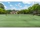 Community tennis court surrounded by trees and greenery at 11220 Avocet Ln # 104, Raleigh, NC 27617