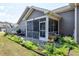 Cozy screened back porch showcasing beautiful landscaping at 115 Thornwhistle Pl, Garner, NC 27529