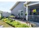 Relaxing screened back porch with a paver patio surrounded by lush landscaping at 115 Thornwhistle Pl, Garner, NC 27529
