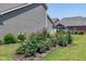 Well-maintained backyard with manicured flower beds and lush green lawn at 115 Thornwhistle Pl, Garner, NC 27529