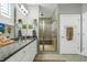 Modern bathroom featuring granite counters, white cabinets, decorative art, and a glass-enclosed shower at 115 Thornwhistle Pl, Garner, NC 27529