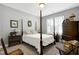 Cozy bedroom featuring a four-poster bed, neutral colors, and plantation shutters at 115 Thornwhistle Pl, Garner, NC 27529
