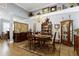 Formal dining room with elegant chandelier, hardwood floors, and china cabinet at 115 Thornwhistle Pl, Garner, NC 27529