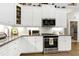 Updated kitchen features granite counters, white cabinets, and stainless appliances at 115 Thornwhistle Pl, Garner, NC 27529
