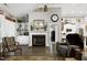 Inviting living room featuring a fireplace, built-in shelves, hardwood floors, and neutral paint at 115 Thornwhistle Pl, Garner, NC 27529
